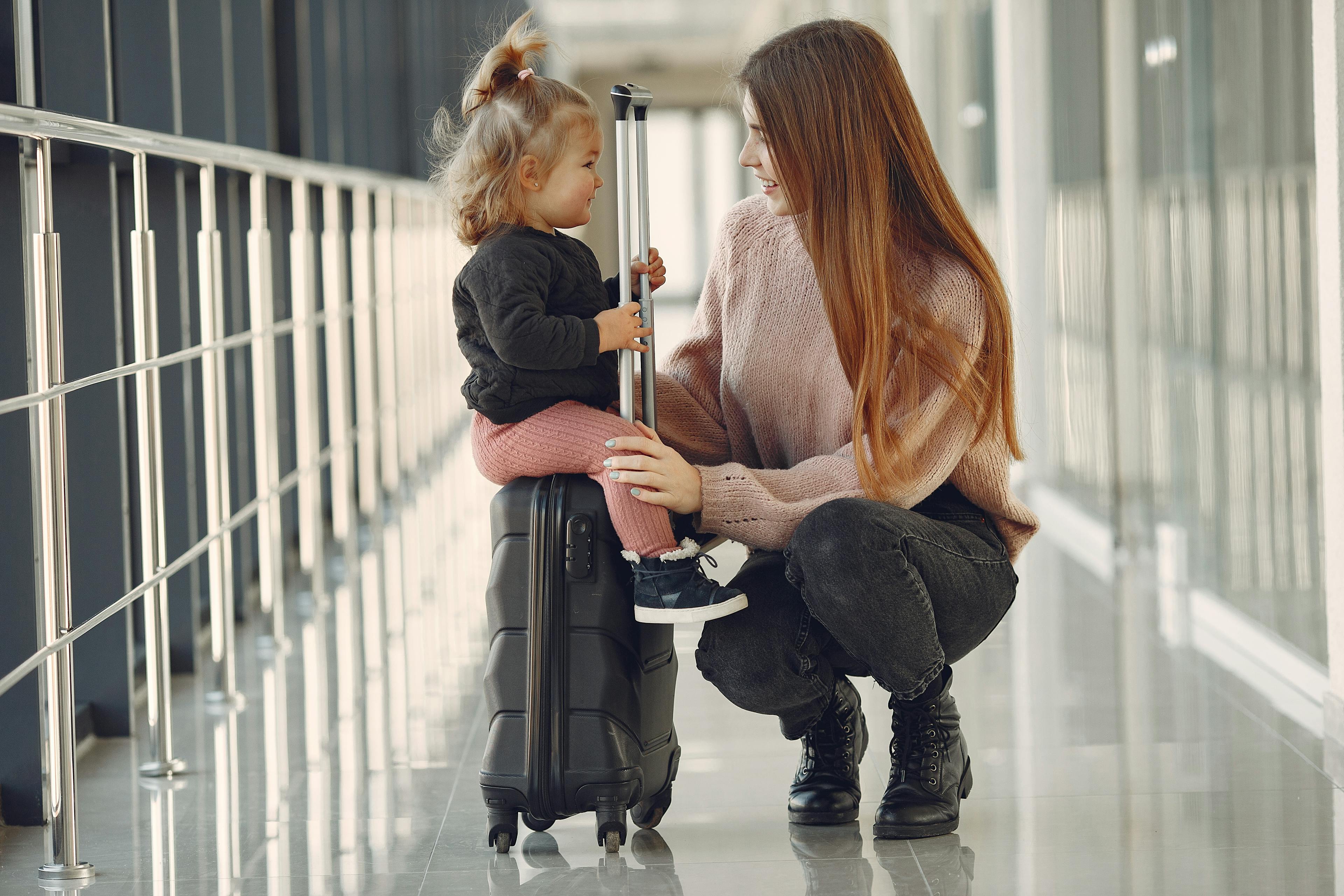 Mother and daughter sharing a moment at the airport before their next adventure.